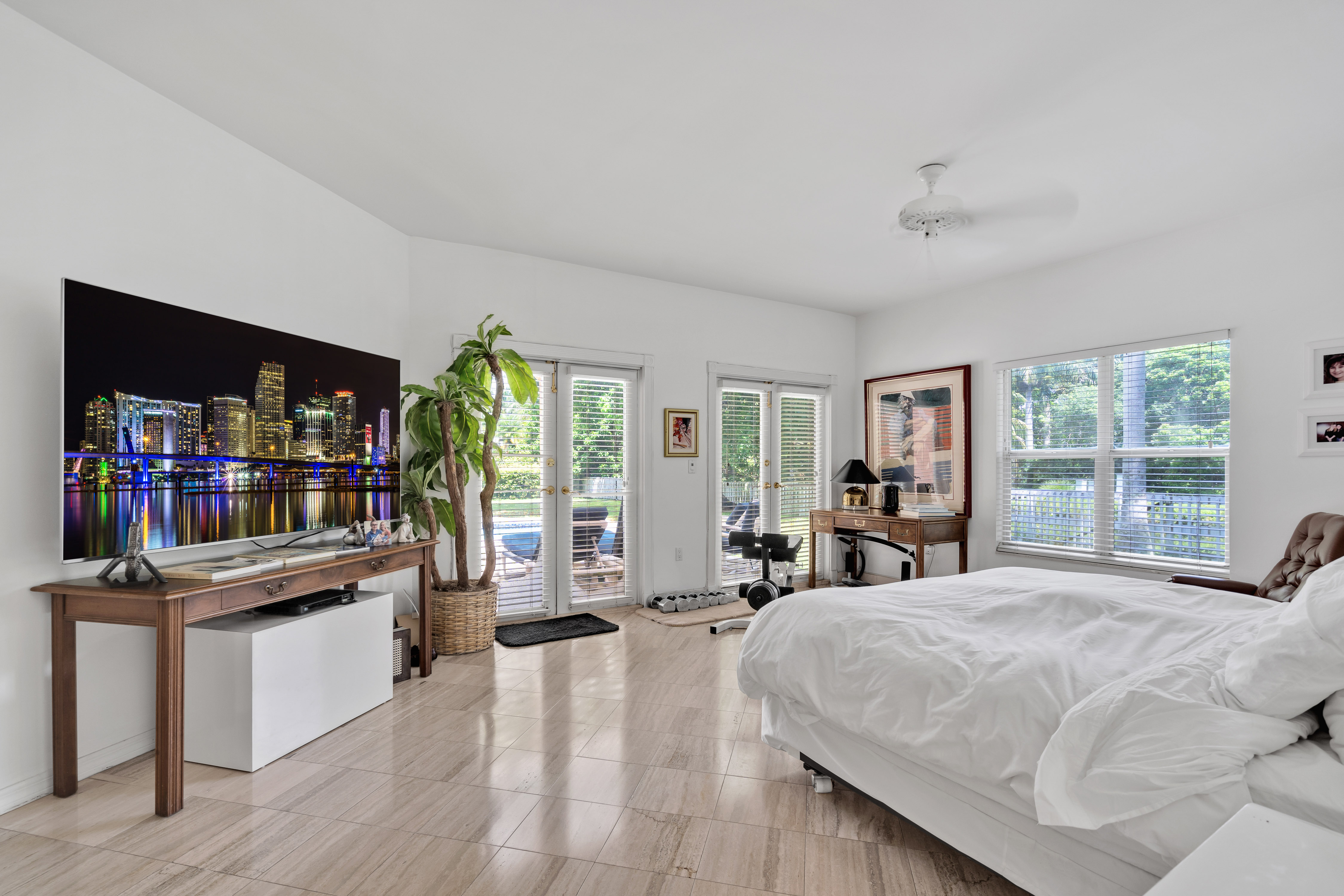 8768 Southwest 62nd Court Miami, FL 33156 - Photo 33 of 56 a large bedroom with a bed large window and a book shelf