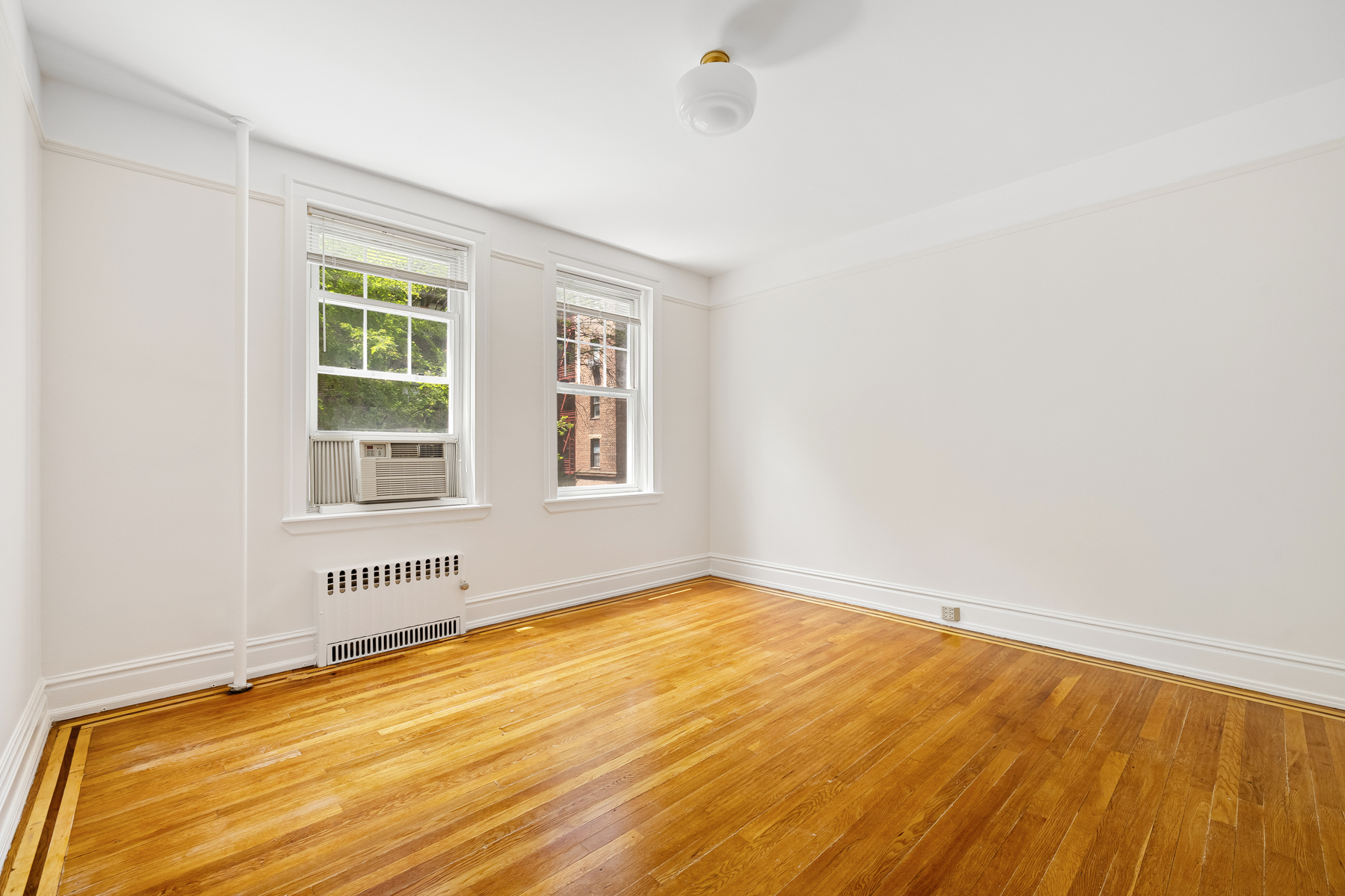 35-27 76th Street, Unit 21 Queens, NY 11372 - Photo 14 of 24 an empty room with a window