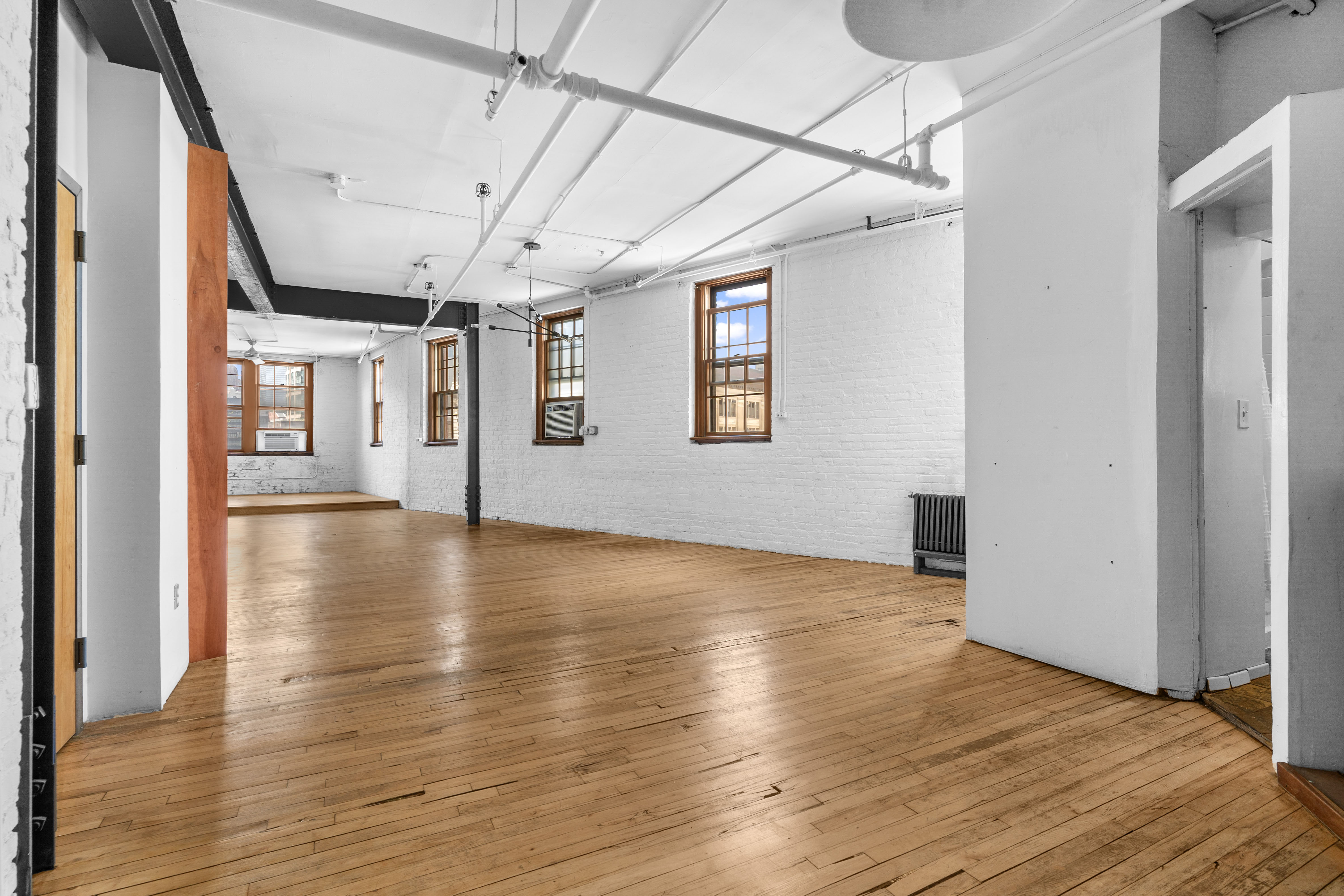210 Spring Street, Unit 5 Manhattan, NY 10012 - Photo 4 of 10 a view of a livingroom with wooden floor