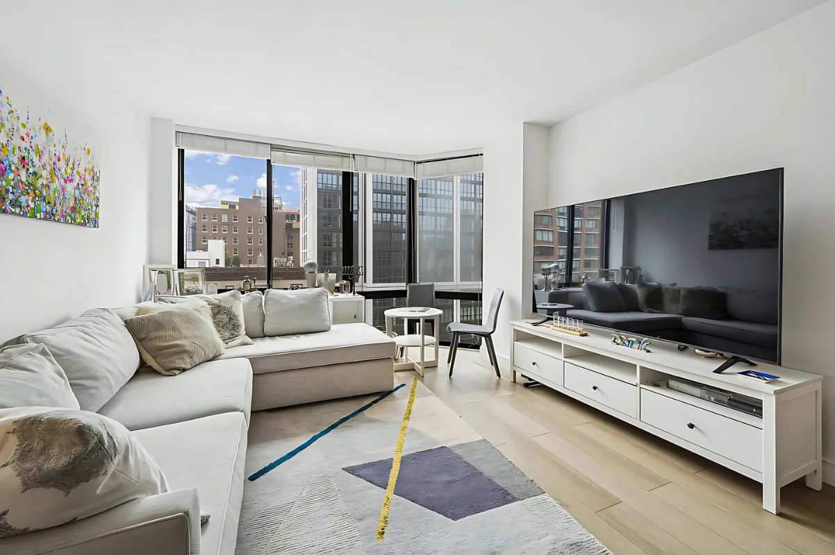 215 West 95th Street, Unit 9J Manhattan, NY 10025 - Photo 1 of 11 a living room with furniture and a flat screen tv