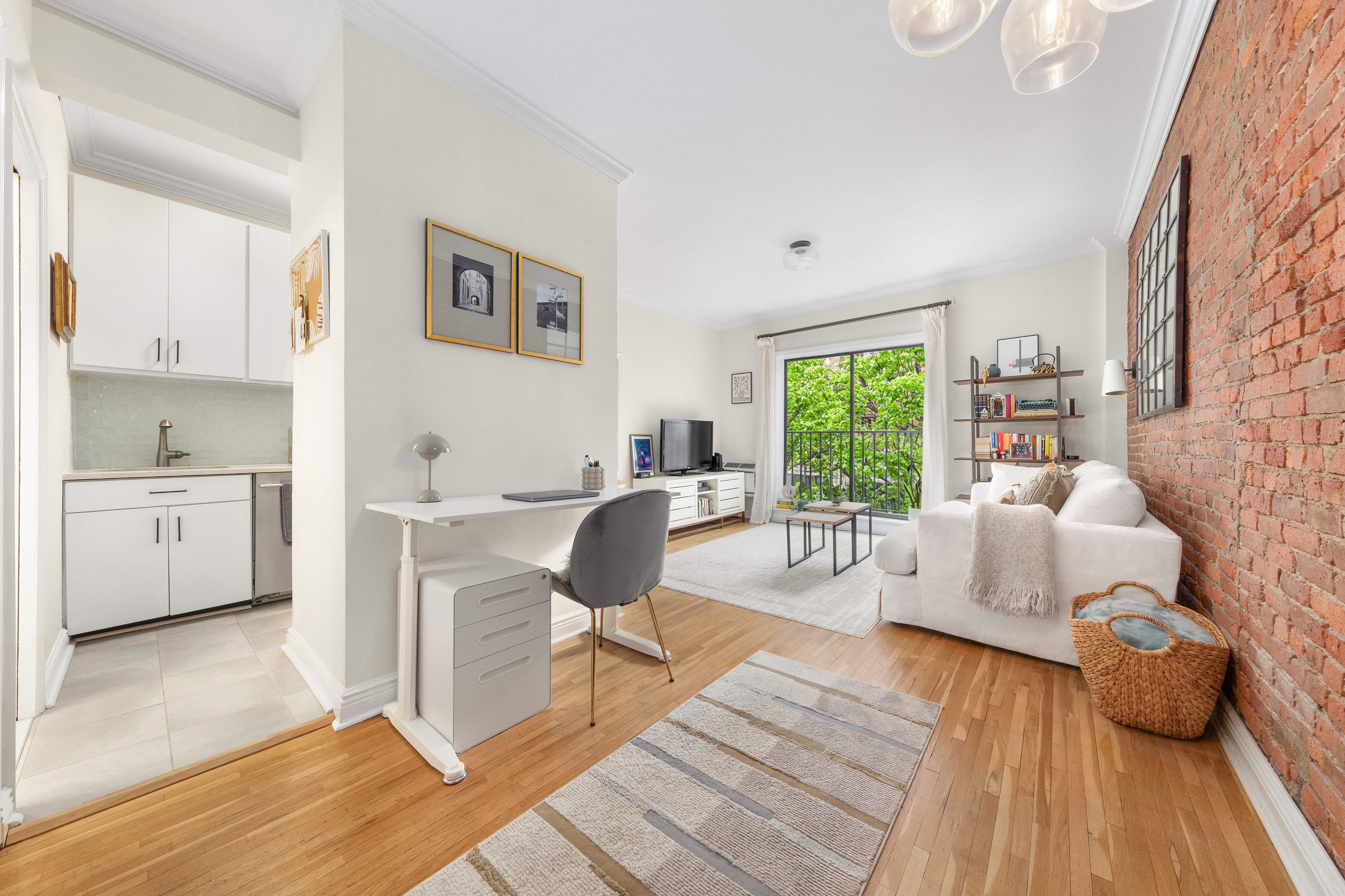 207 East 21st Street, Unit 5B Manhattan, NY 10010 - Photo 2 of 7 a living room with furniture and a large window