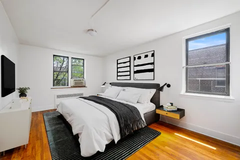 a bedroom with a bed and a flat screen tv