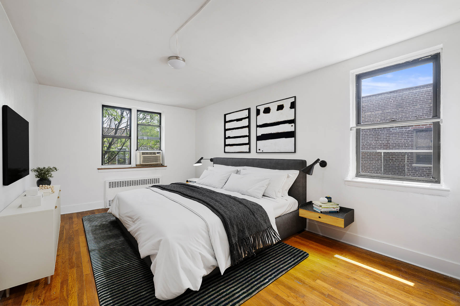 2420 Morris Avenue, Unit 6K Bronx, NY 10468 - Photo 1 of 7 a bedroom with a bed and a flat screen tv