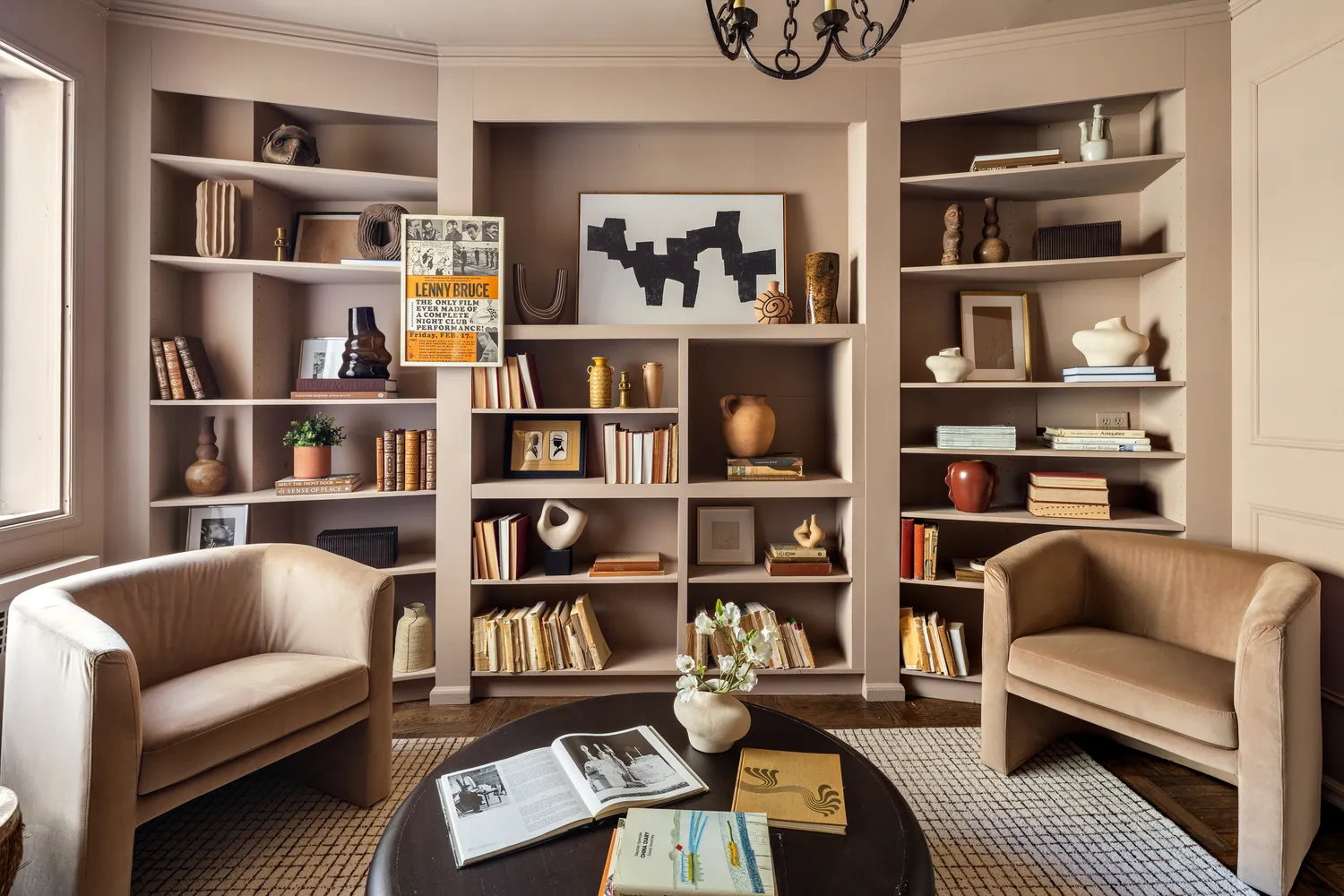 a living room with furniture cabinets and a book shelf