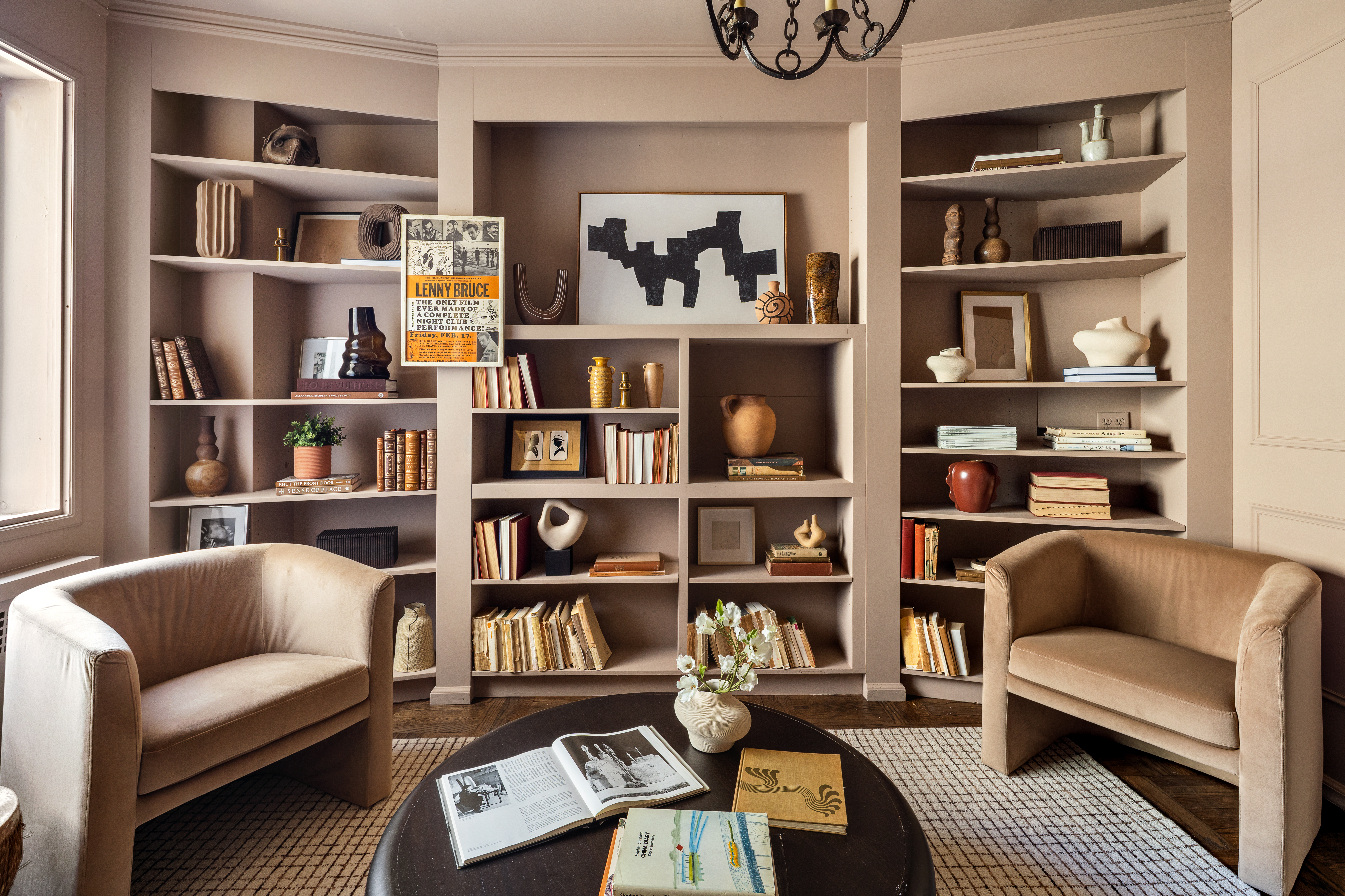 860 5th Avenue, Unit 12E Manhattan, NY 10065 - Photo 8 of 16 a living room with furniture cabinets and a book shelf