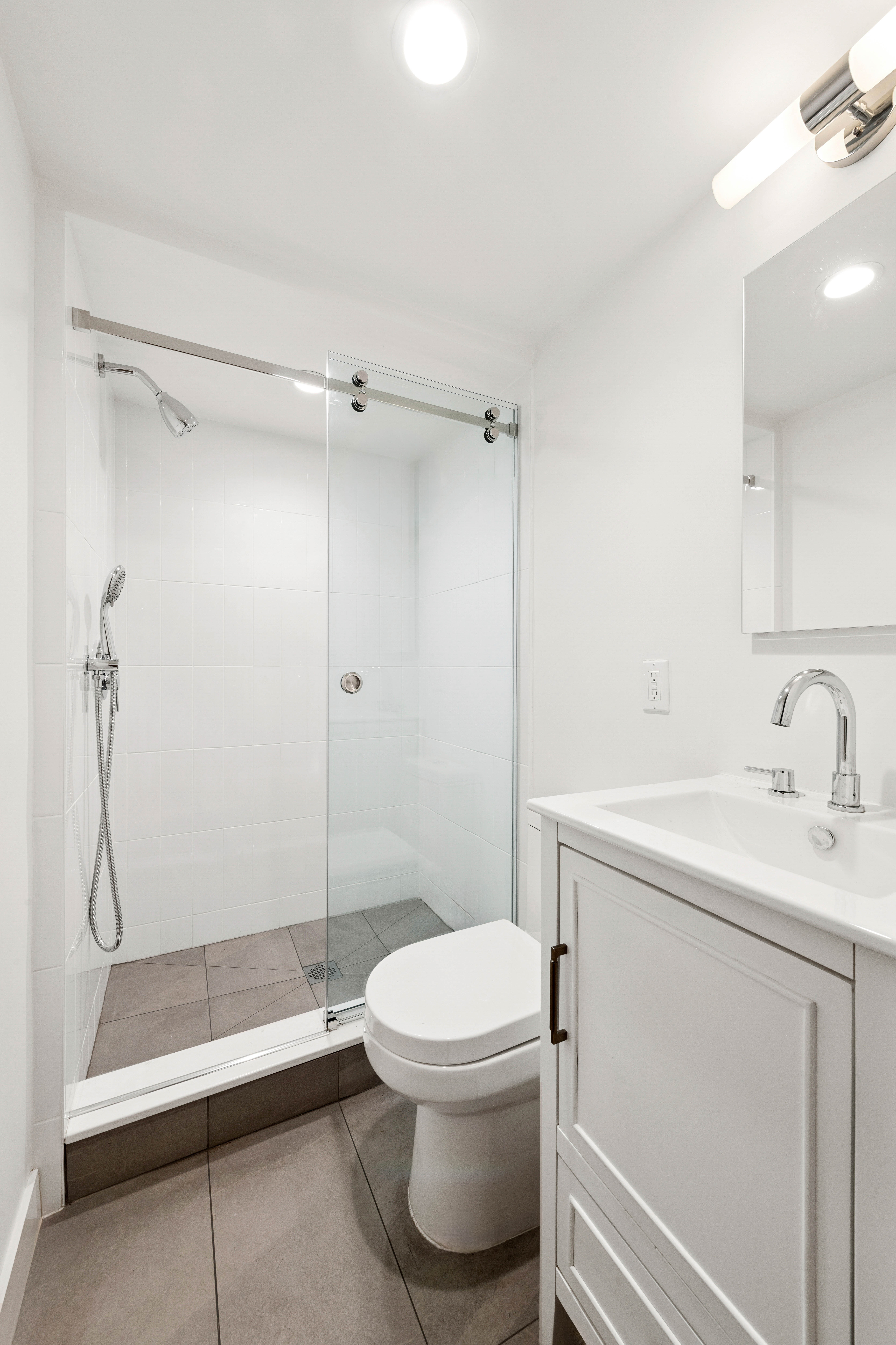 765 Greenwich Street, Unit 1 Manhattan, NY 10014 - Photo 12 of 14 a bathroom with a sink a toilet and shower