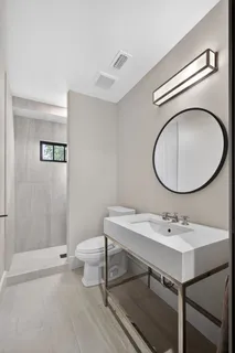 a bathroom with a sink toilet and a mirror