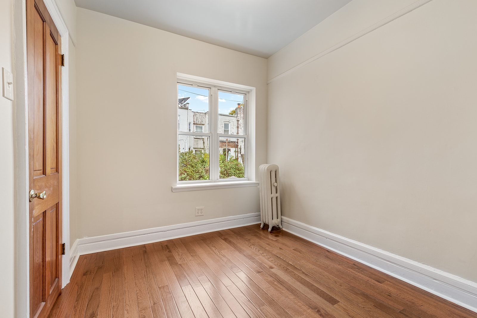 181 Terrace Place Brooklyn, NY 11218 - Photo 15 of 22 an empty room with wooden floor and windows
