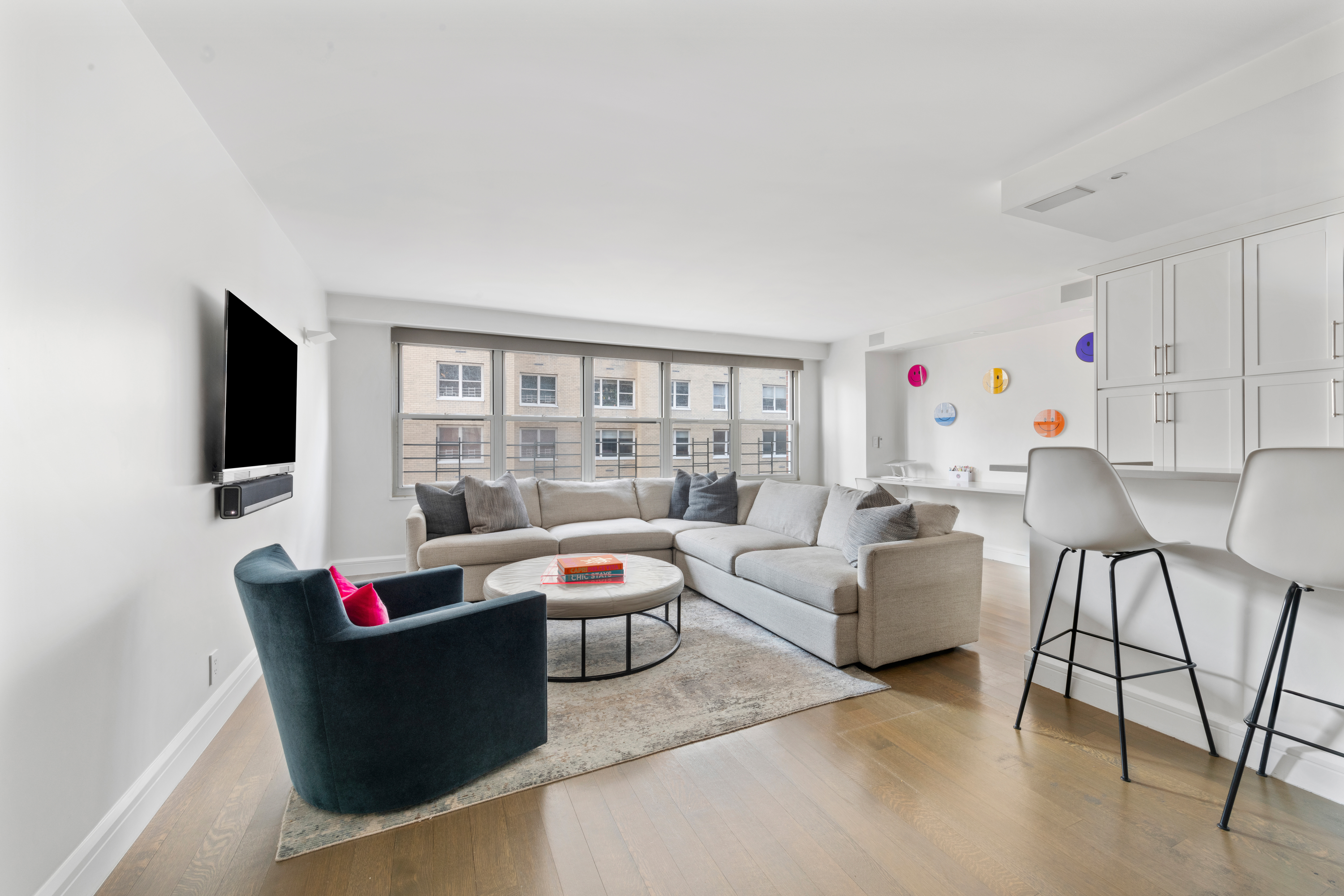 363 East 76th Street, Unit 7C Manhattan, NY 10021 - Photo 1 of 19 a living room with furniture and a flat screen tv