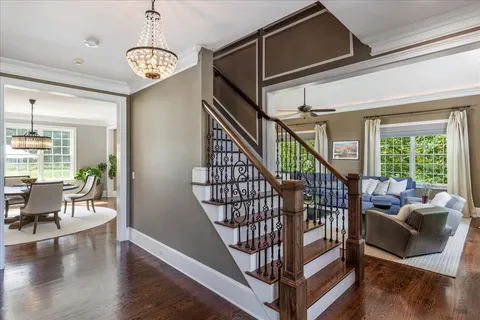 a living room with furniture fireplace and a large window