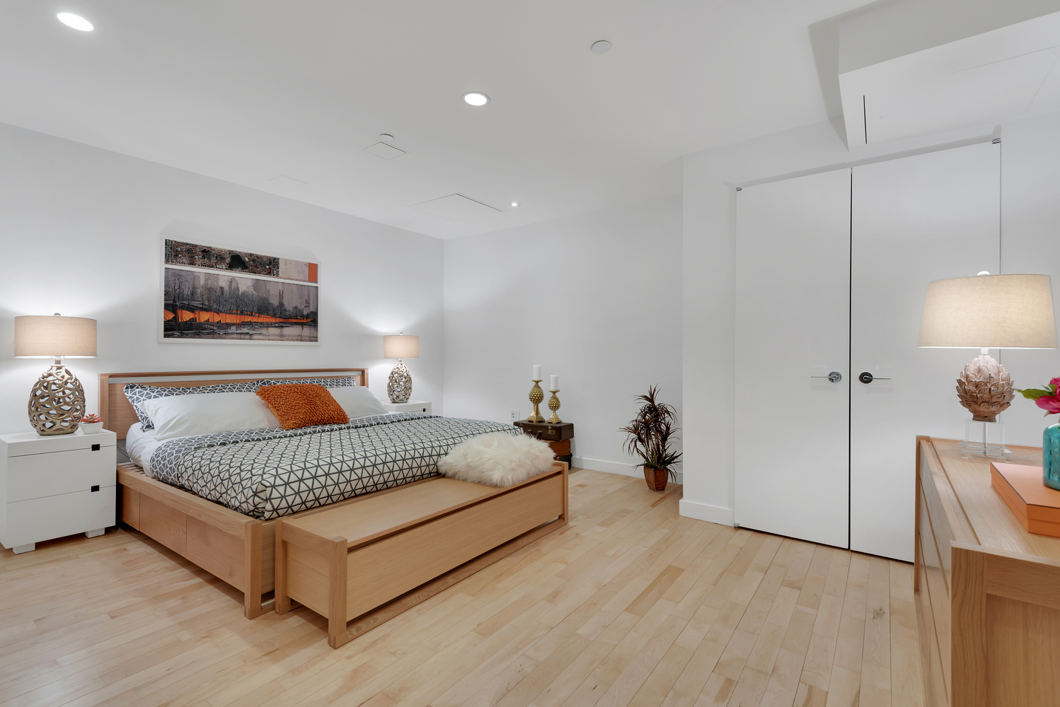 15 Broad Street, Unit 1230 Manhattan, NY 10005 - Photo 5 of 23 a spacious bedroom with a bed and a lamp