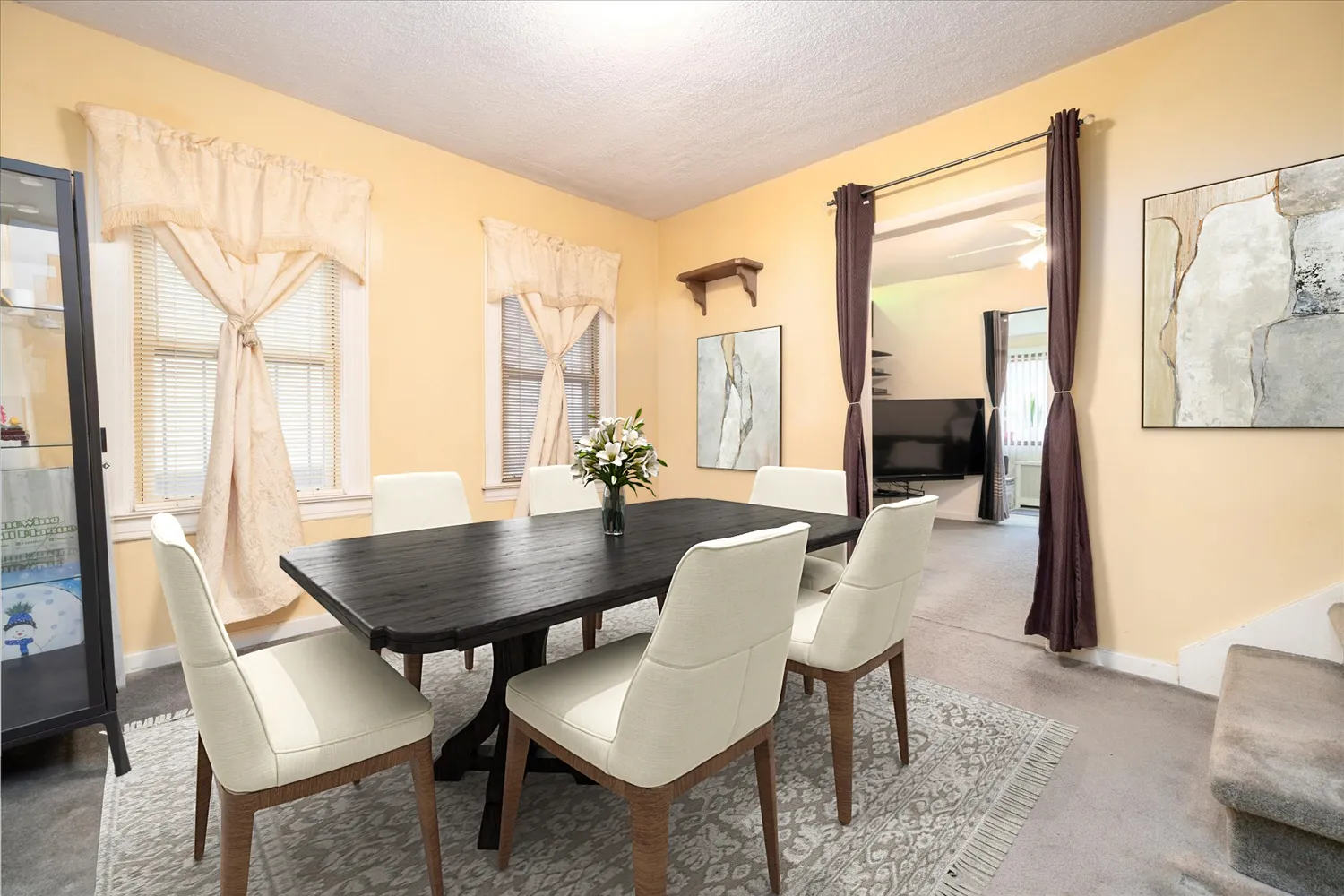 a view of a dining room with furniture and a window