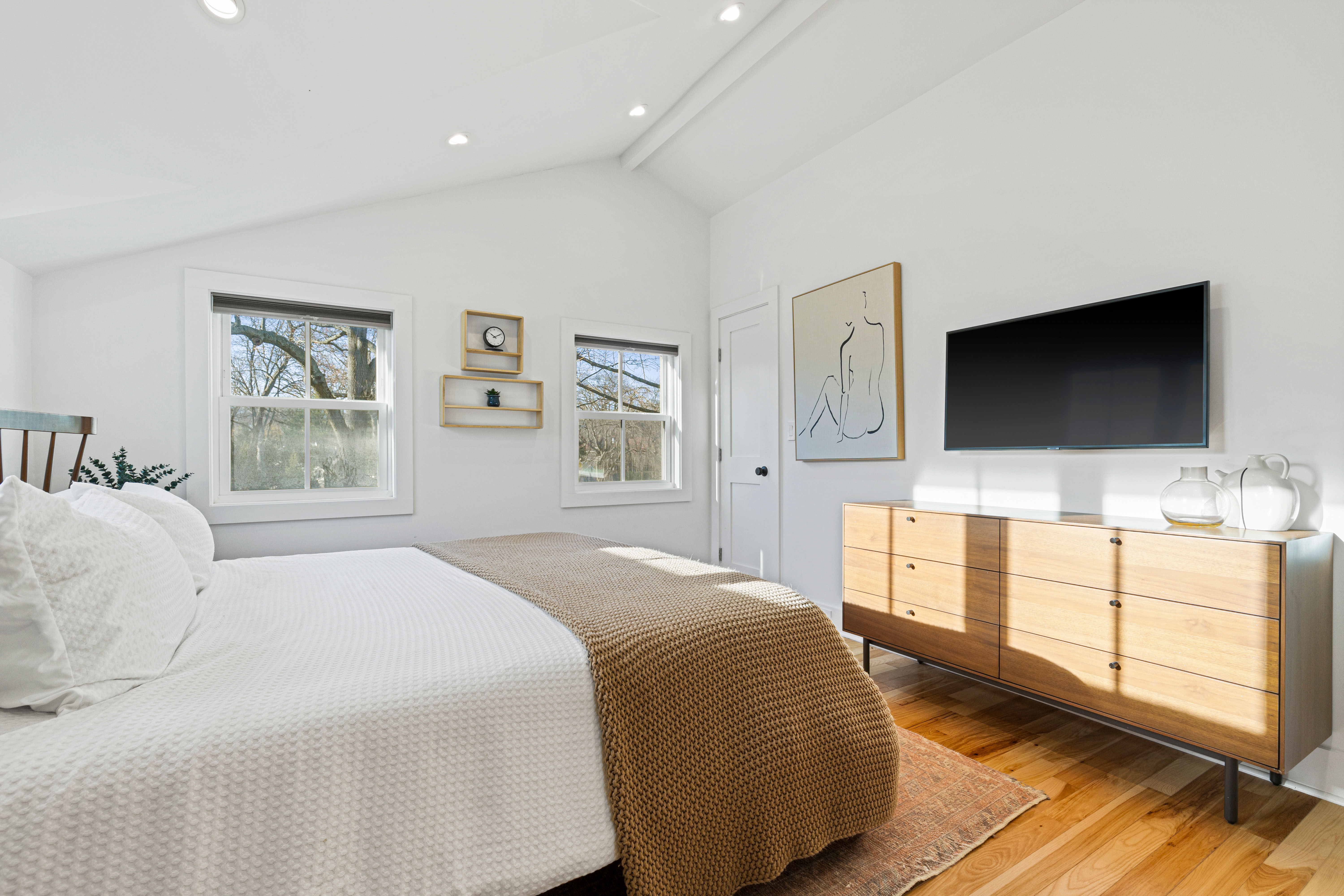 467 Midland Avenue Rye, NY 10580 - Photo 9 of 19 a bedroom with a large bed and a flat screen tv