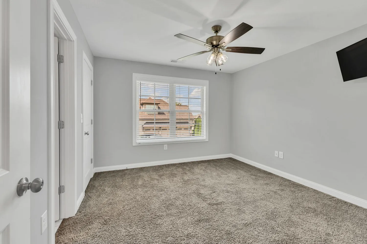 a view of a house with a big yard and a large tree