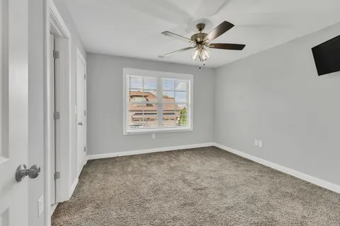 a view of a house with a big yard and a large tree
