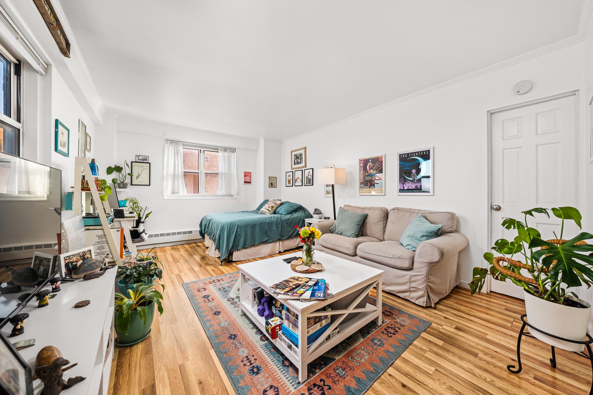 a living room with furniture a flat screen tv and a table