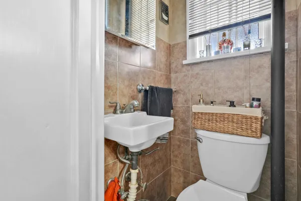 a bathroom with a toilet a sink and a mirror