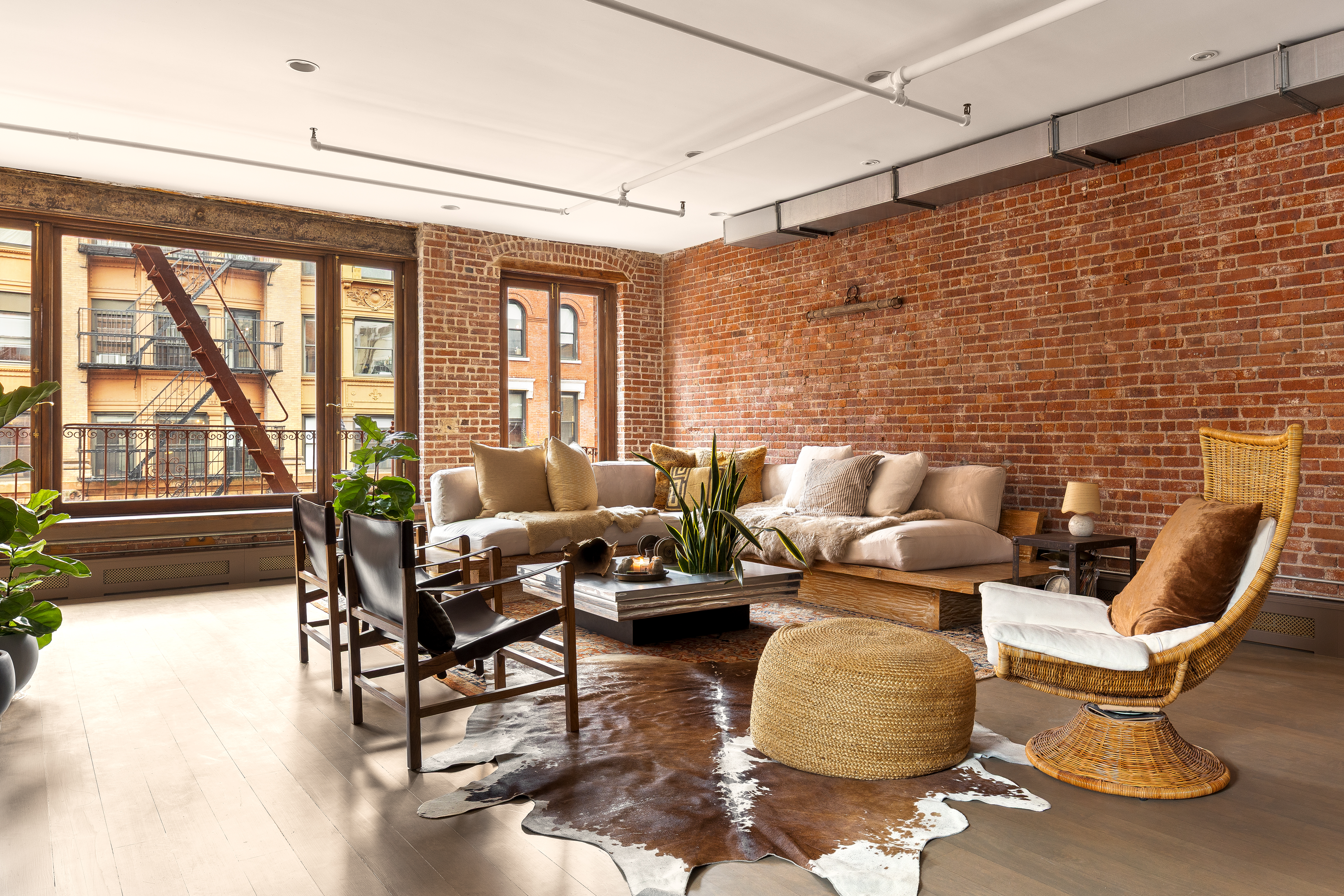182 Lafayette Street, Unit 5 Manhattan, NY 10013 - Photo 2 of 19 a living room with furniture and a floor to ceiling window