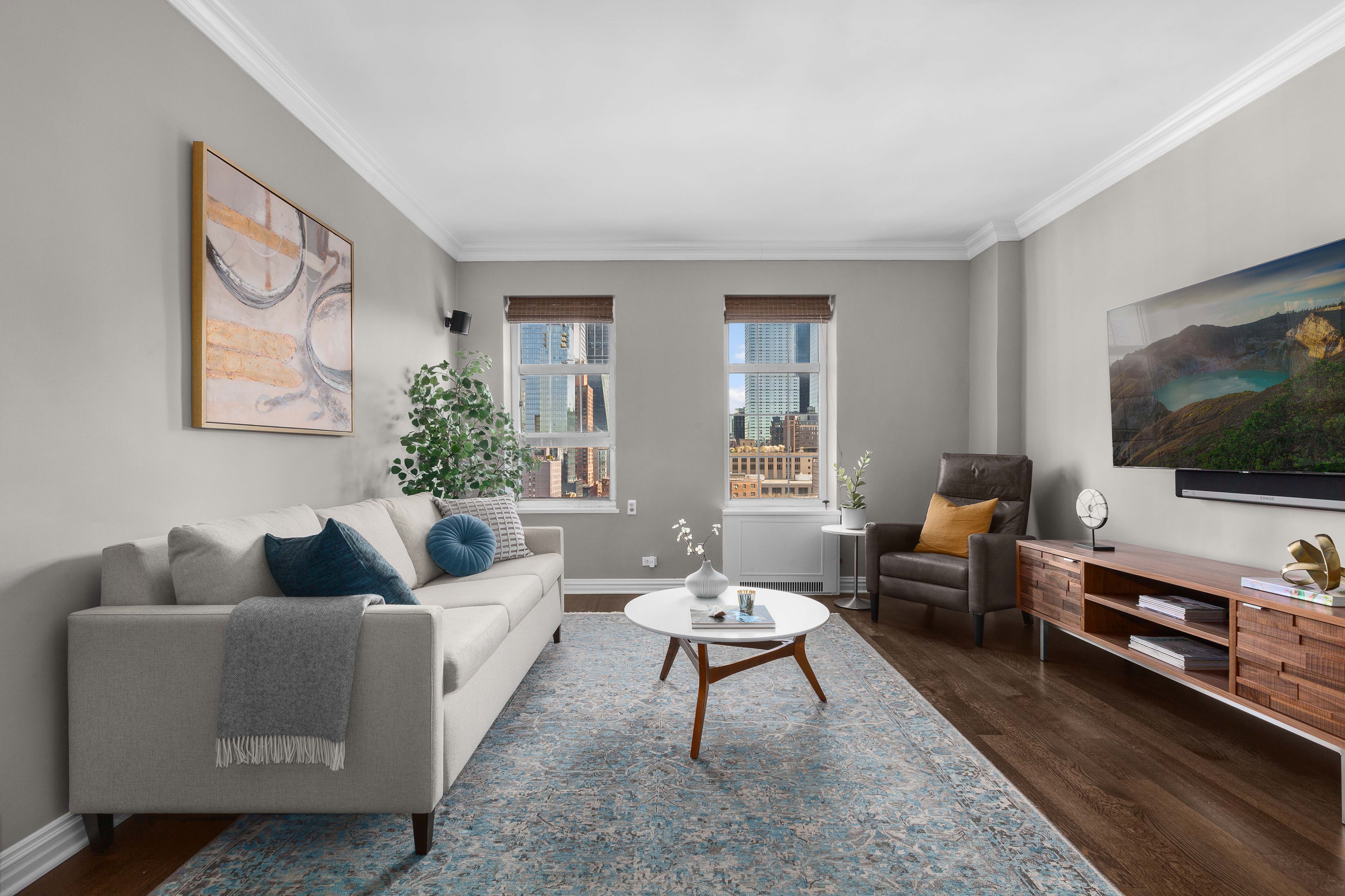 470 West 24th Street, Unit 16H Manhattan, NY 10011 - Photo 2 of 13 a living room with furniture and a flat screen tv