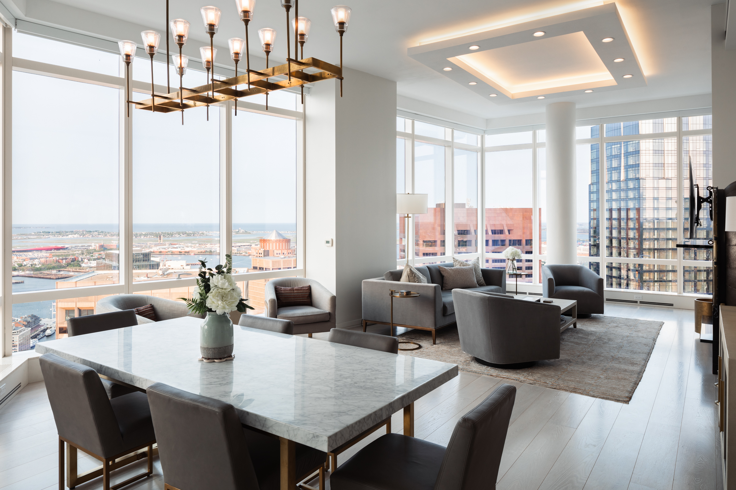 1 Franklin Street, Unit PH2D Boston, MA 02110 - Photo 2 of 26 a dining room with wooden floor and large windows