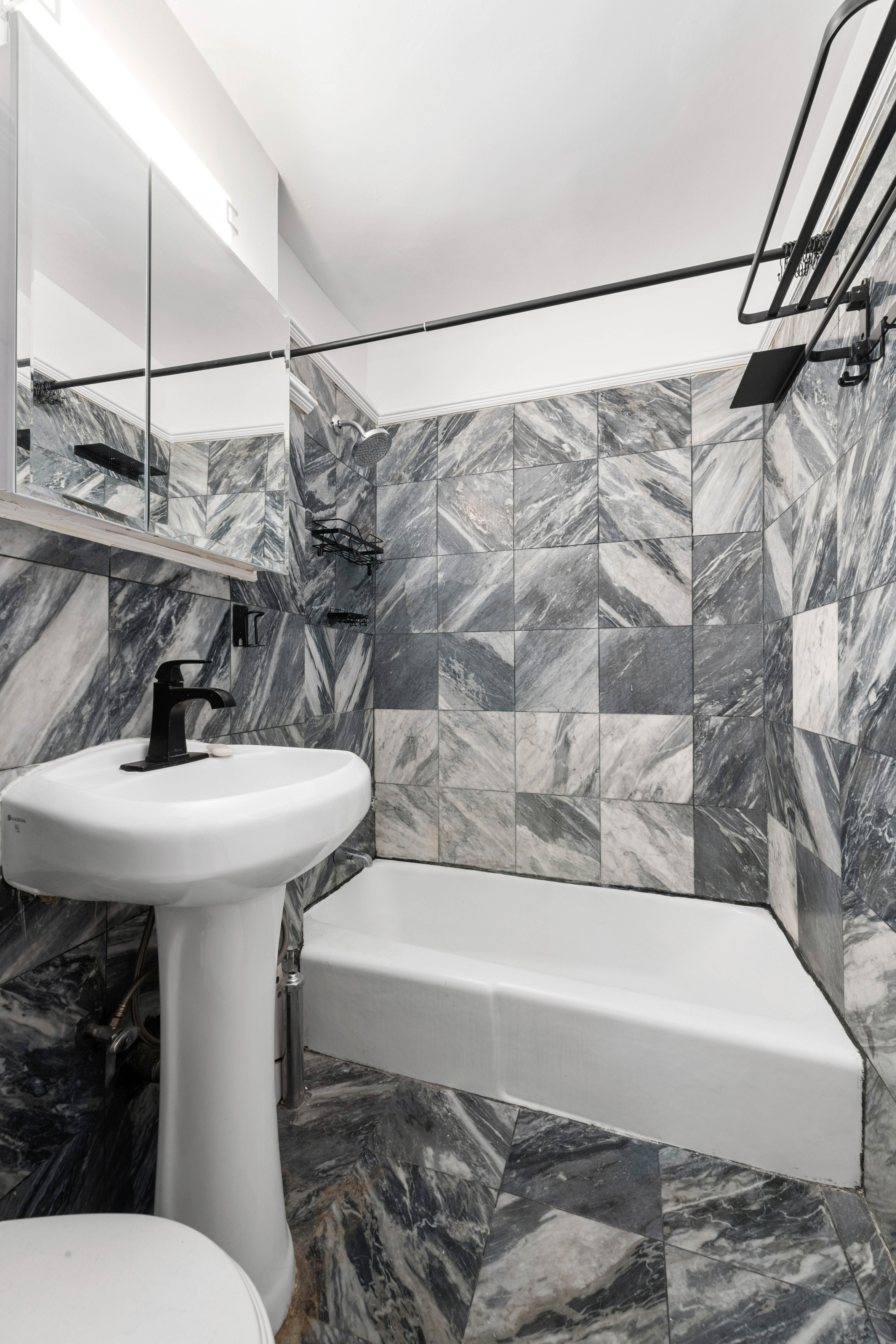 2790 Broadway, Unit 1B Manhattan, NY 10025 - Photo 4 of 8 a bathroom with a sink and a mirror