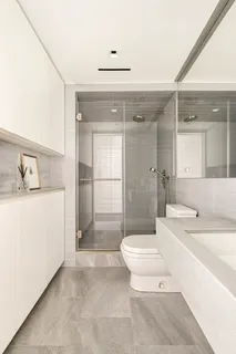 a bathroom with a sink a toilet and shower