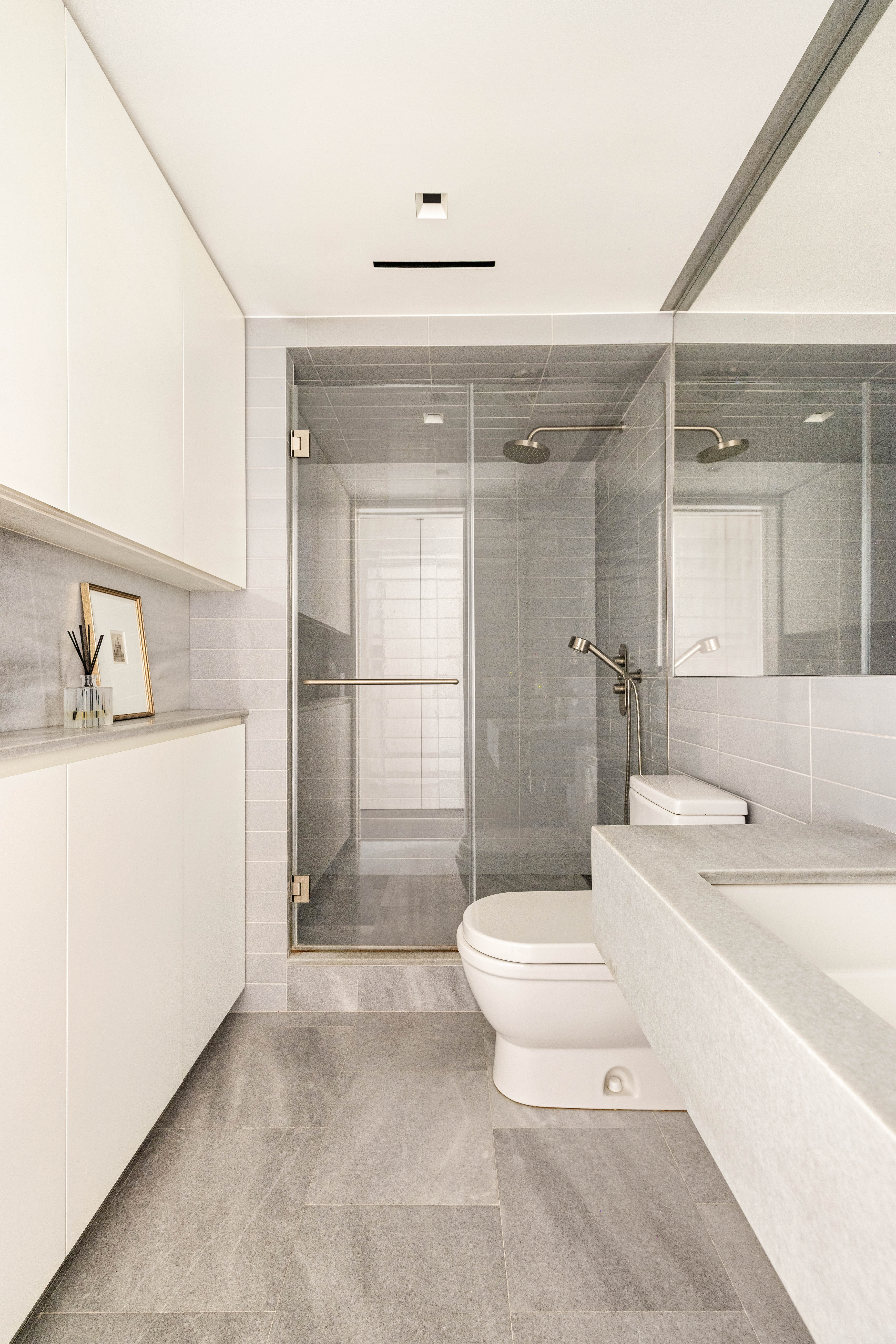 2 Tudor City Place, Unit 8DS Manhattan, NY 10017 - Photo 9 of 14 a bathroom with a sink a toilet and shower