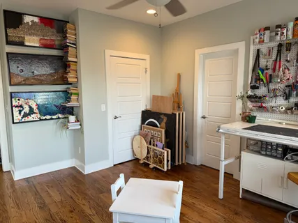 a view of room with workspace and wooden floor