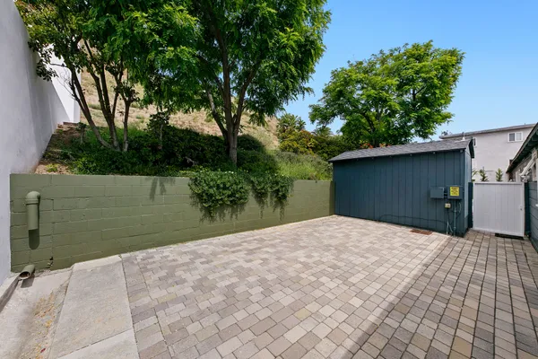 a backyard of a house with plants and trees