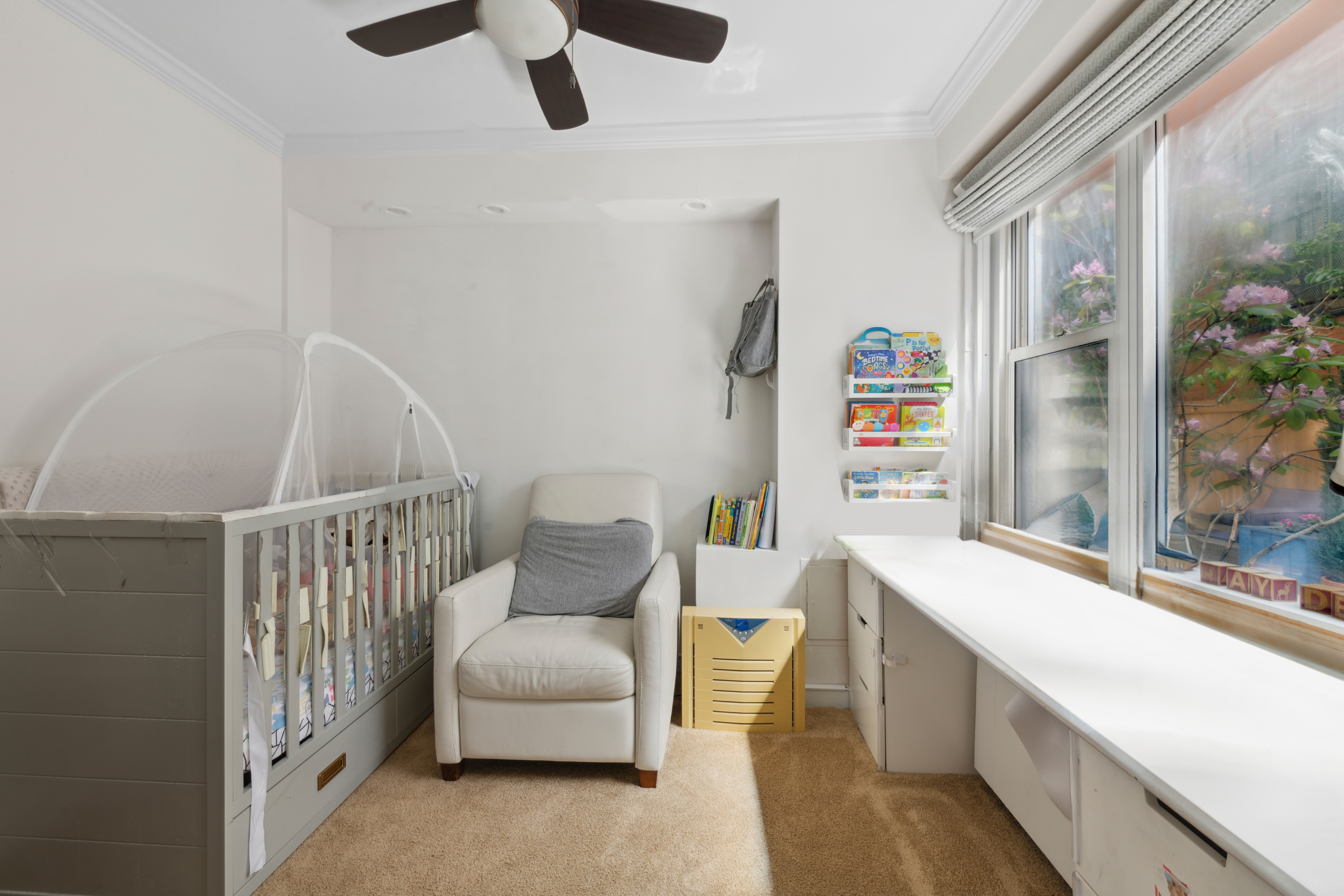 400 East 77th Street, Unit 1CD Manhattan, NY 10075 - Photo 8 of 18 a living room with furniture and a window