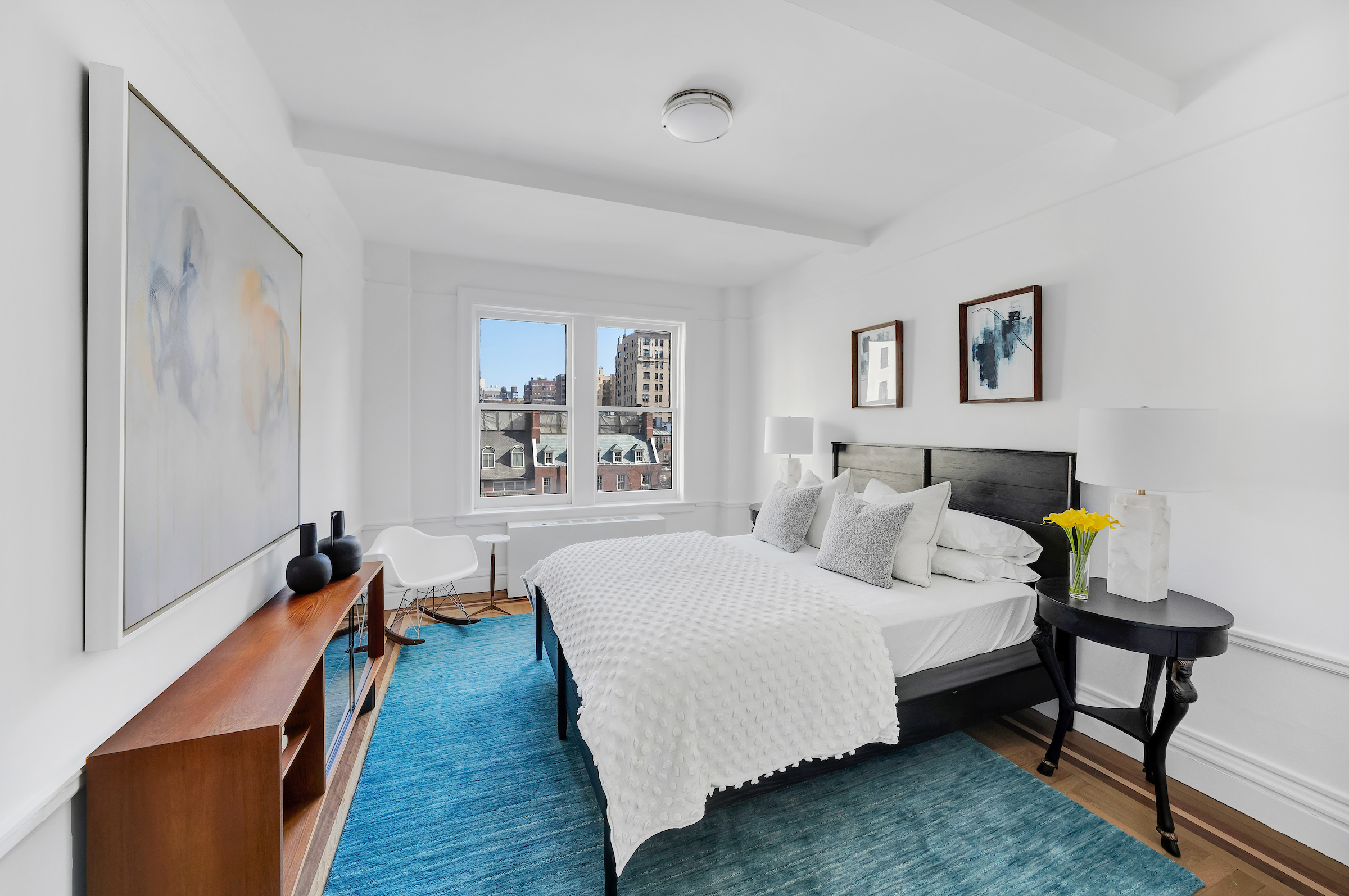 51 East 90th Street, Unit 8D Manhattan, NY 10128 - Photo 8 of 10 a bedroom with a bed and wooden floor