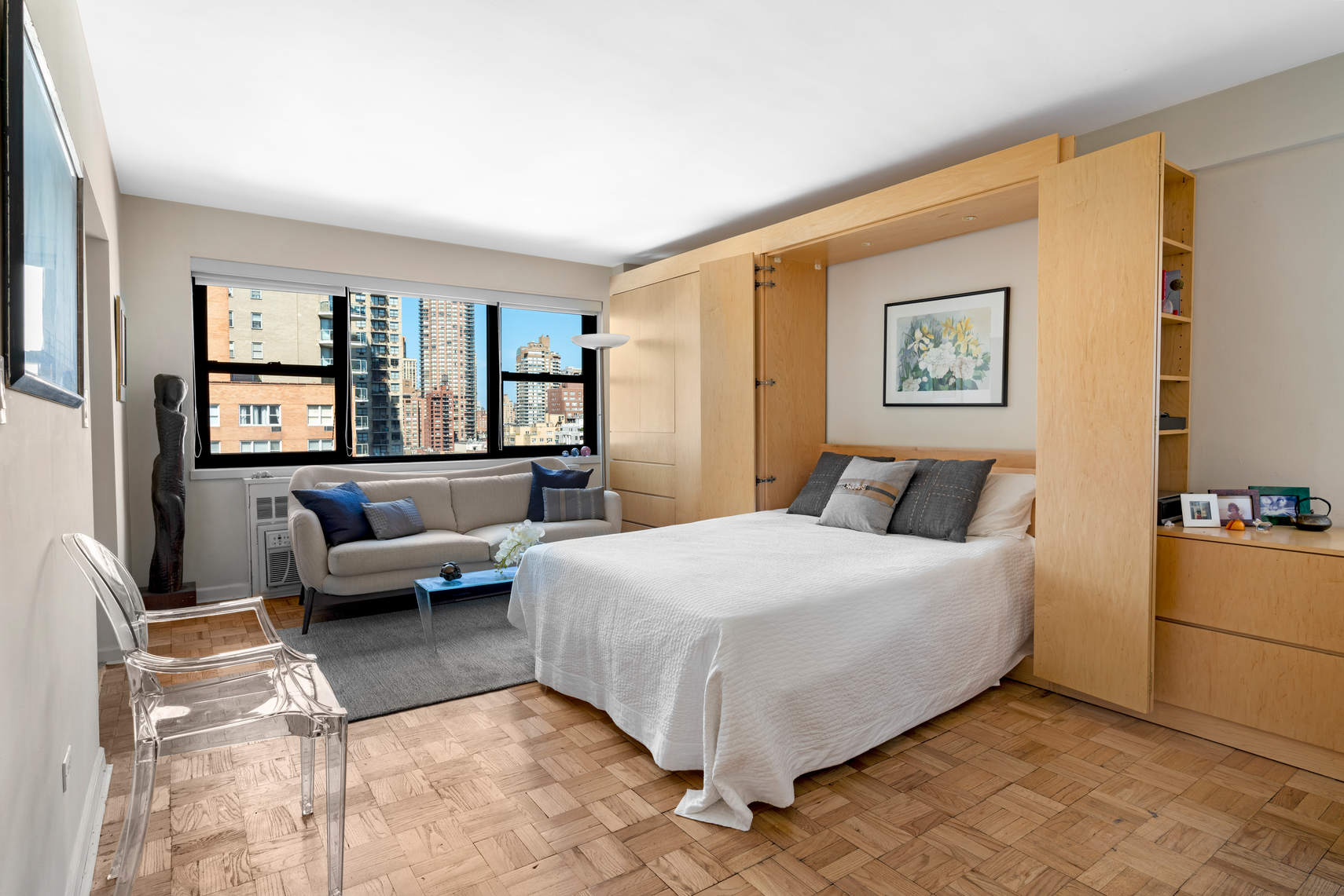 305 East 72nd Street, Unit 13I Manhattan, NY 10021 - Photo 5 of 14 a bedroom with a large bed couch and a window