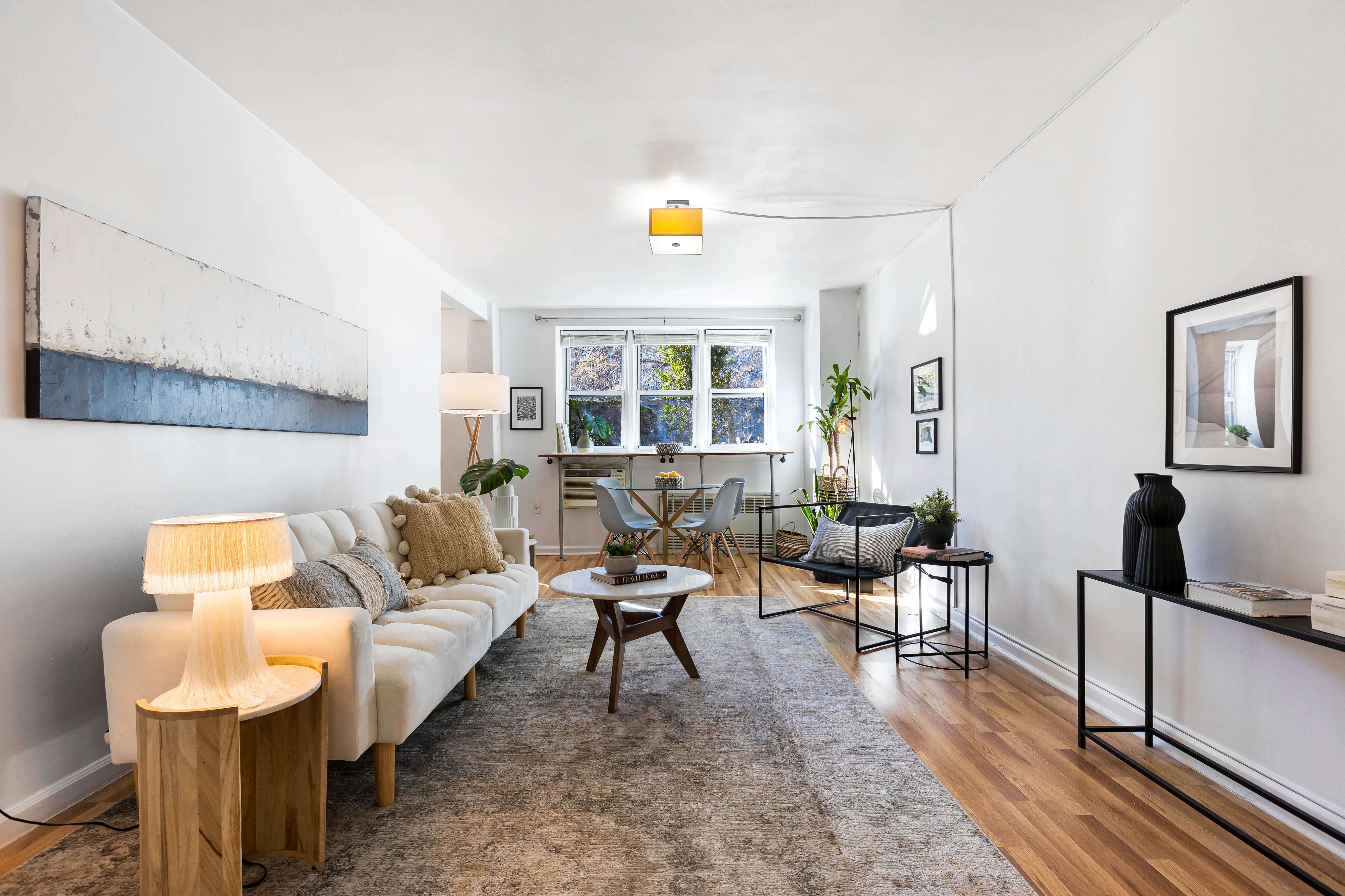 a living room with furniture and wooden floor