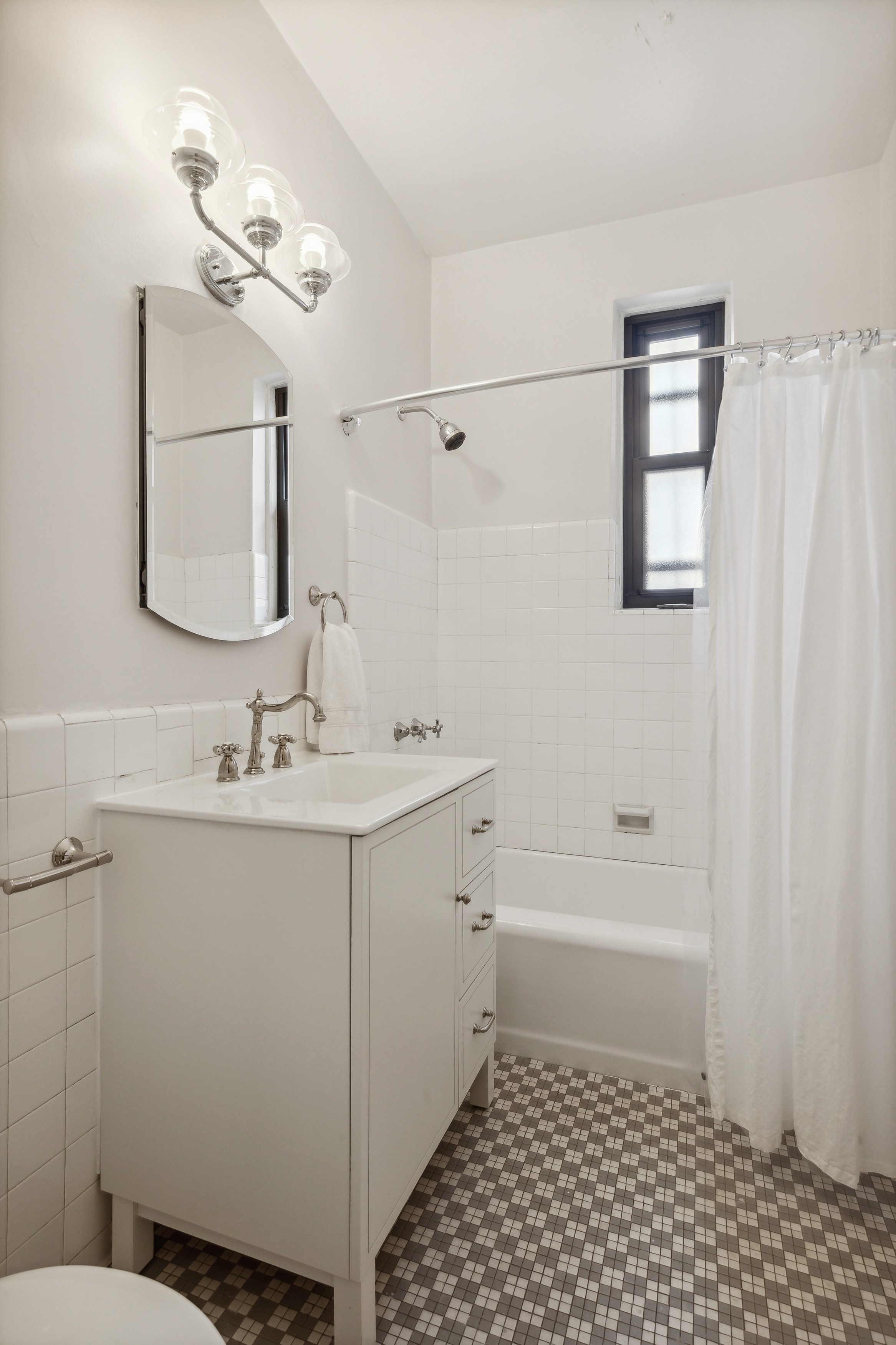 158-18 Riverside Drive West, Unit 2E Manhattan, NY 10032 - Photo 9 of 22 a bathroom with a sink a toilet and shower