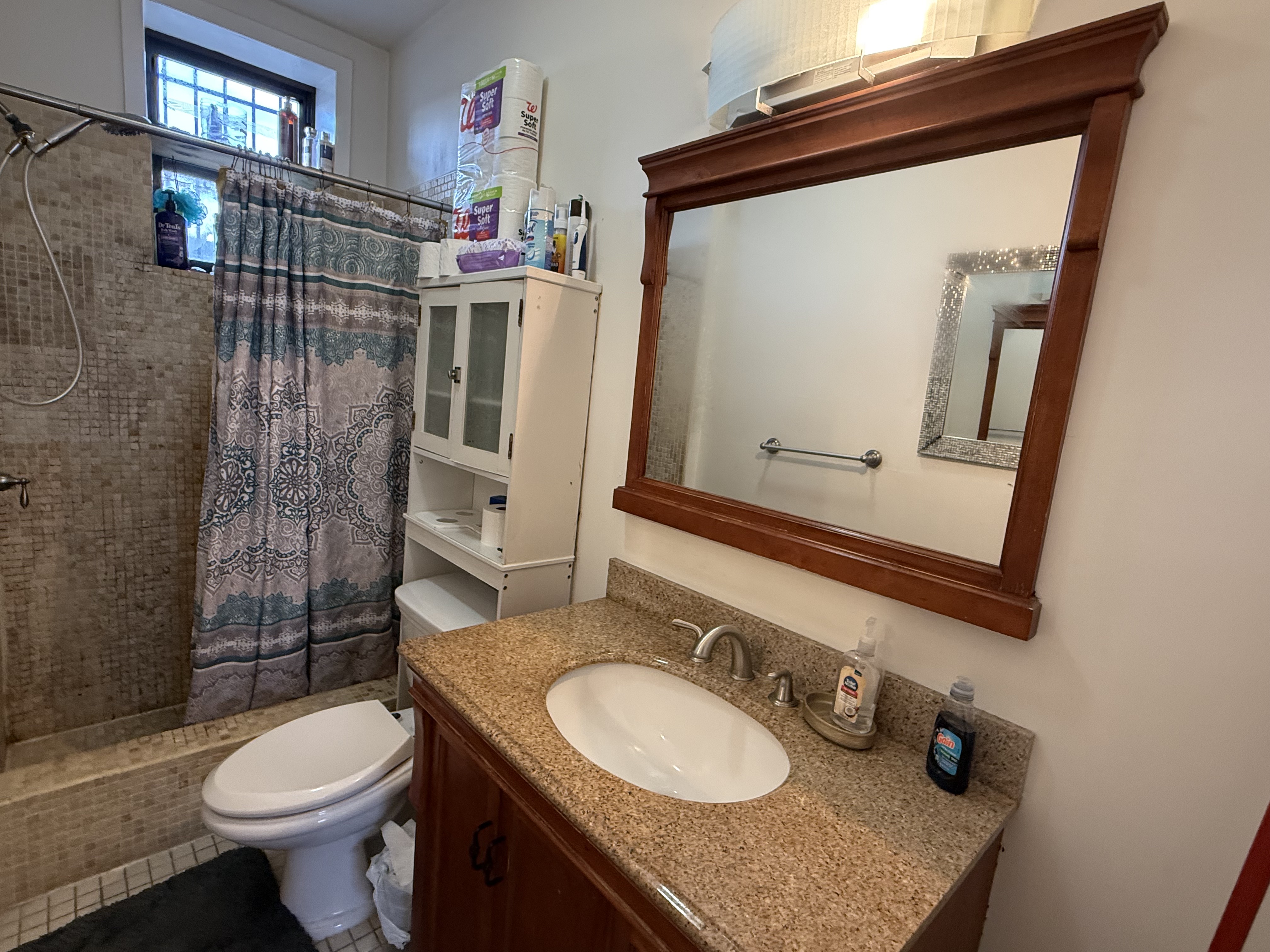 599 60th Street West New York, NJ 07093 - Photo 16 of 17 a bathroom with a granite countertop toilet sink and mirror