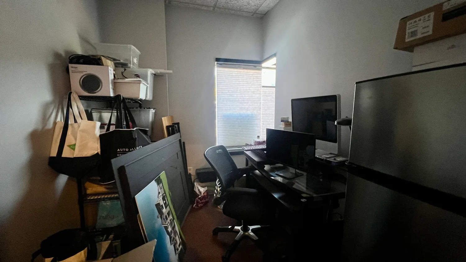 a view of a workspace with furniture and gym equipment