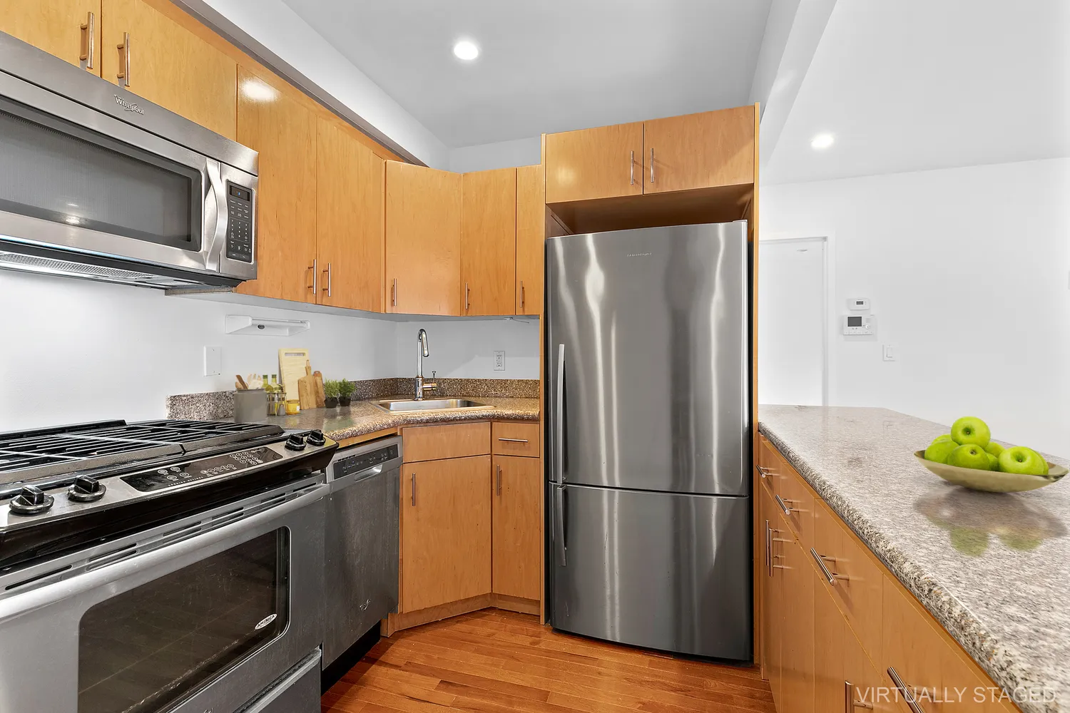 a kitchen with stainless steel appliances granite countertop a refrigerator stove and microwave