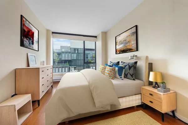 a bedroom with a bed and wooden floor