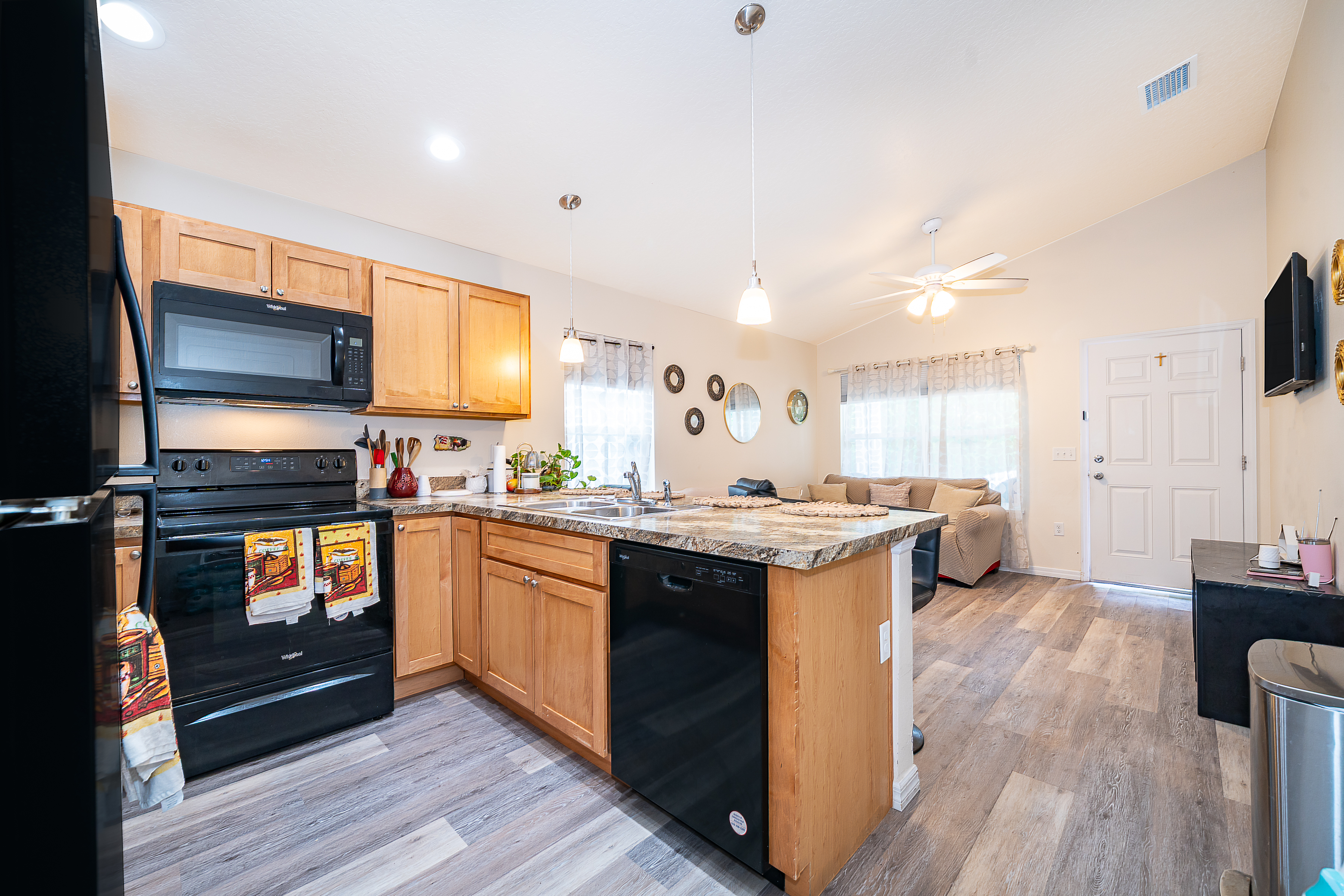 1360 Cottage Circle Tavares, FL 32778 - Photo 11 of 25 a kitchen with a sink stove and wooden cabinets