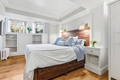 a bed room with a bed and a window