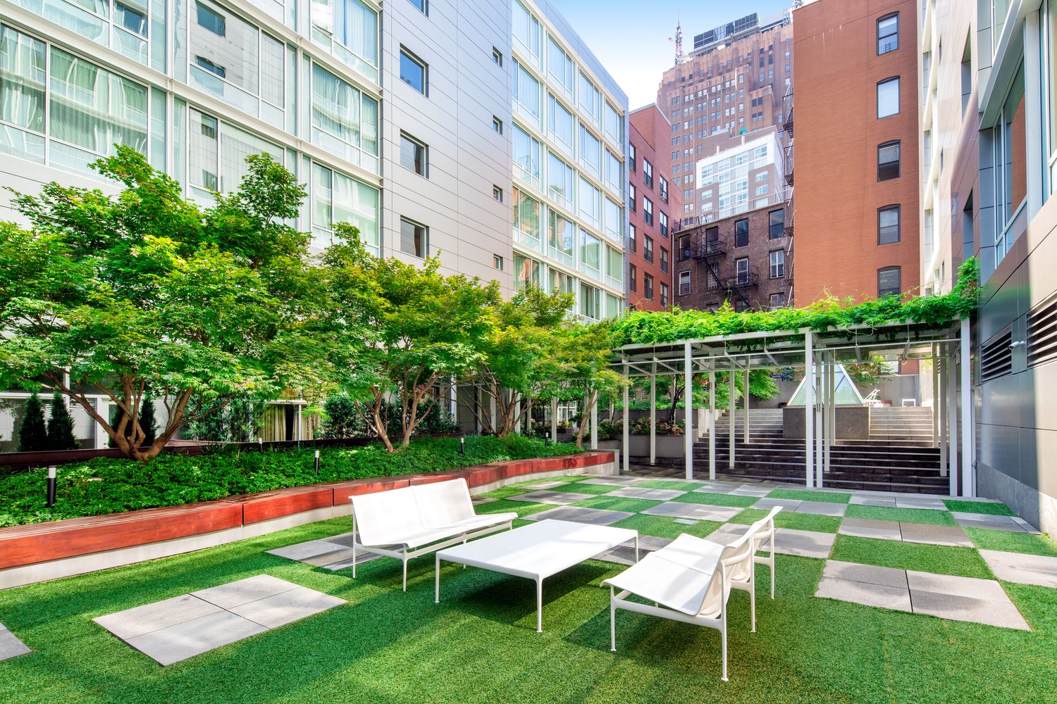 311 West Broadway, Unit 5G Manhattan, NY 10013 - Photo 9 of 14 a chair and table sitting in backyard of a building