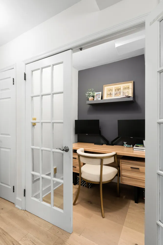a living room with furniture a rug and white walls