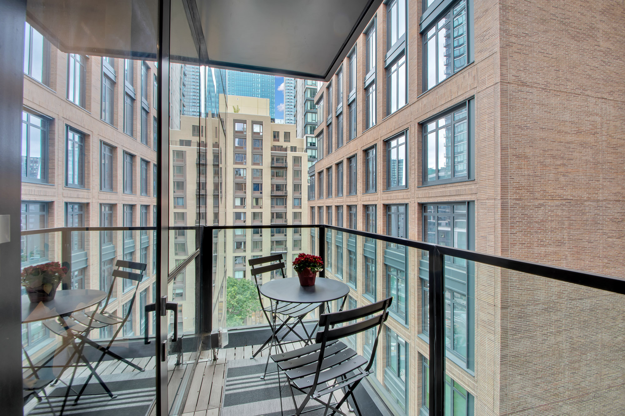 5 Court Square West, Unit 8A Queens, NY 11101 - Photo 6 of 7 a view of a balcony with chairs
