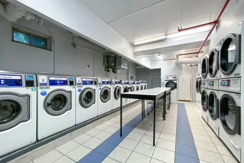 a utility room with dryer washer and a view of living room