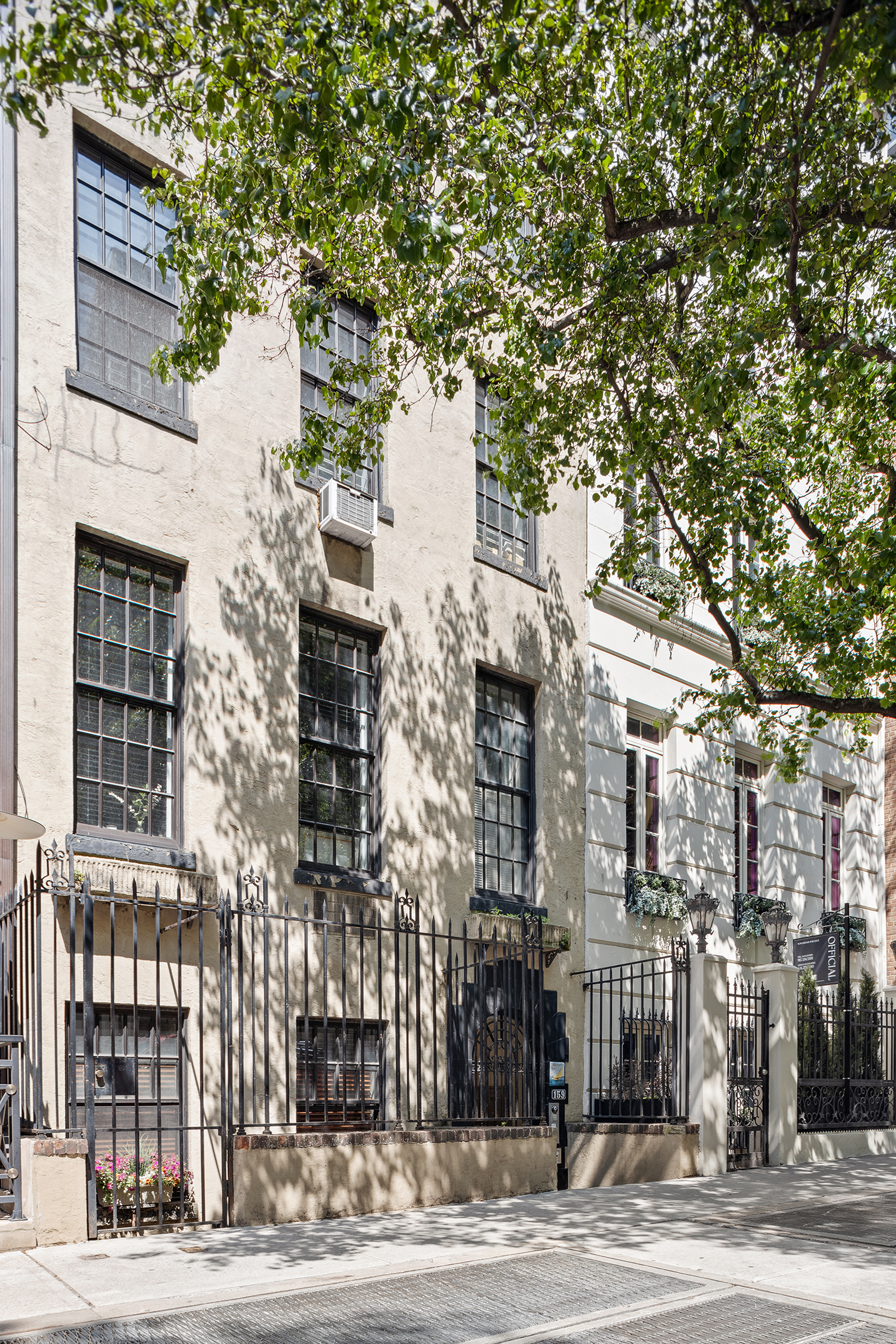 159 East 63rd Street, Unit 2/3 Manhattan, NY 10065 - Photo 12 of 13 a front view of a building with a tree