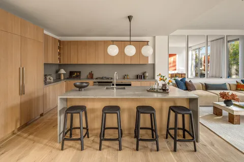 a kitchen with center island table and chairs