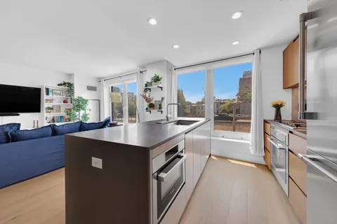 a kitchen with stainless steel appliances granite countertop a sink stove and cabinets