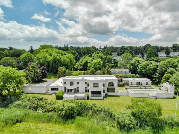 a aerial view of a house with yard and green space