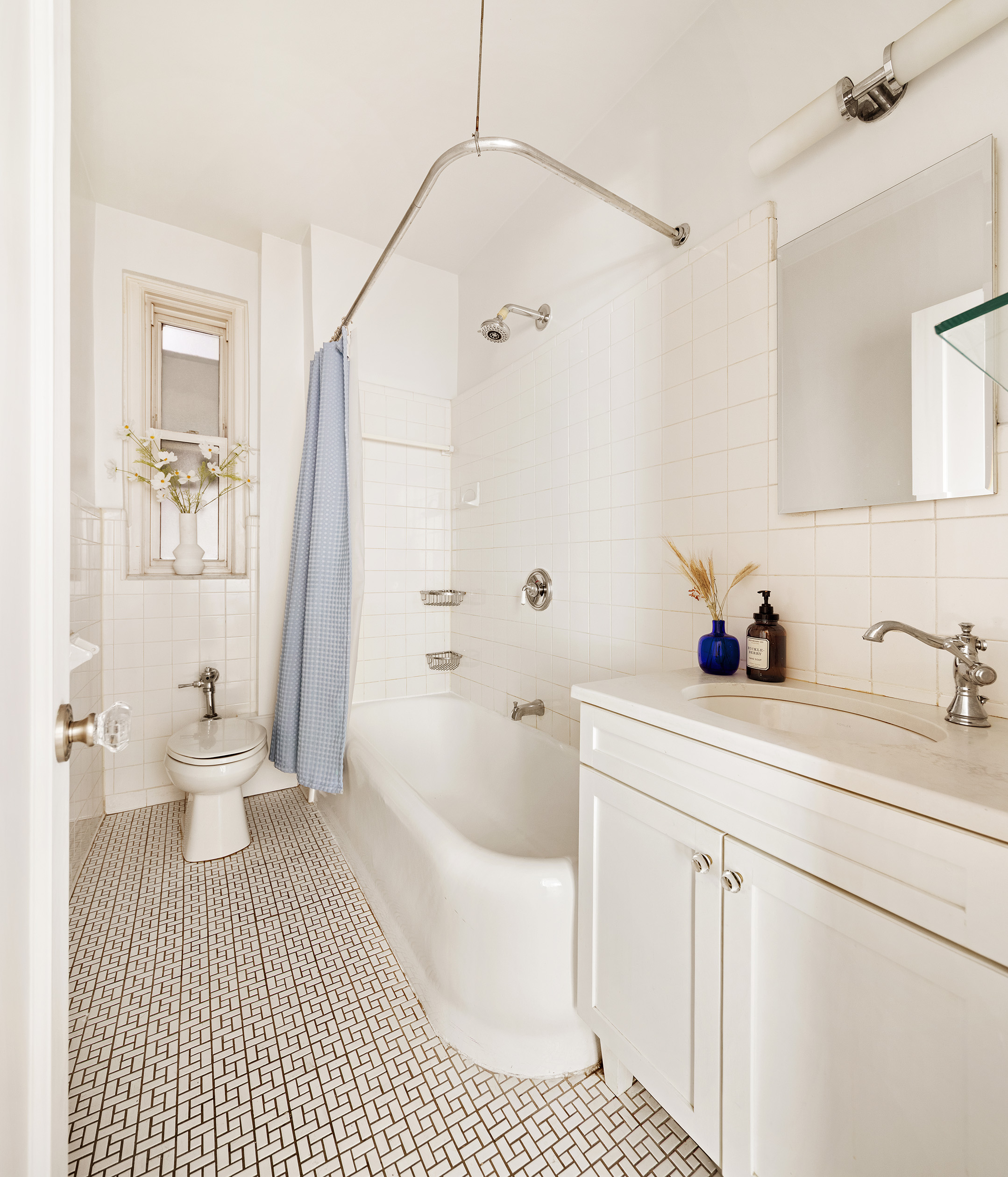 41 5th Avenue, Unit 2F Manhattan, NY 10003 - Photo 6 of 12 a bathroom with a sink a toilet and shower