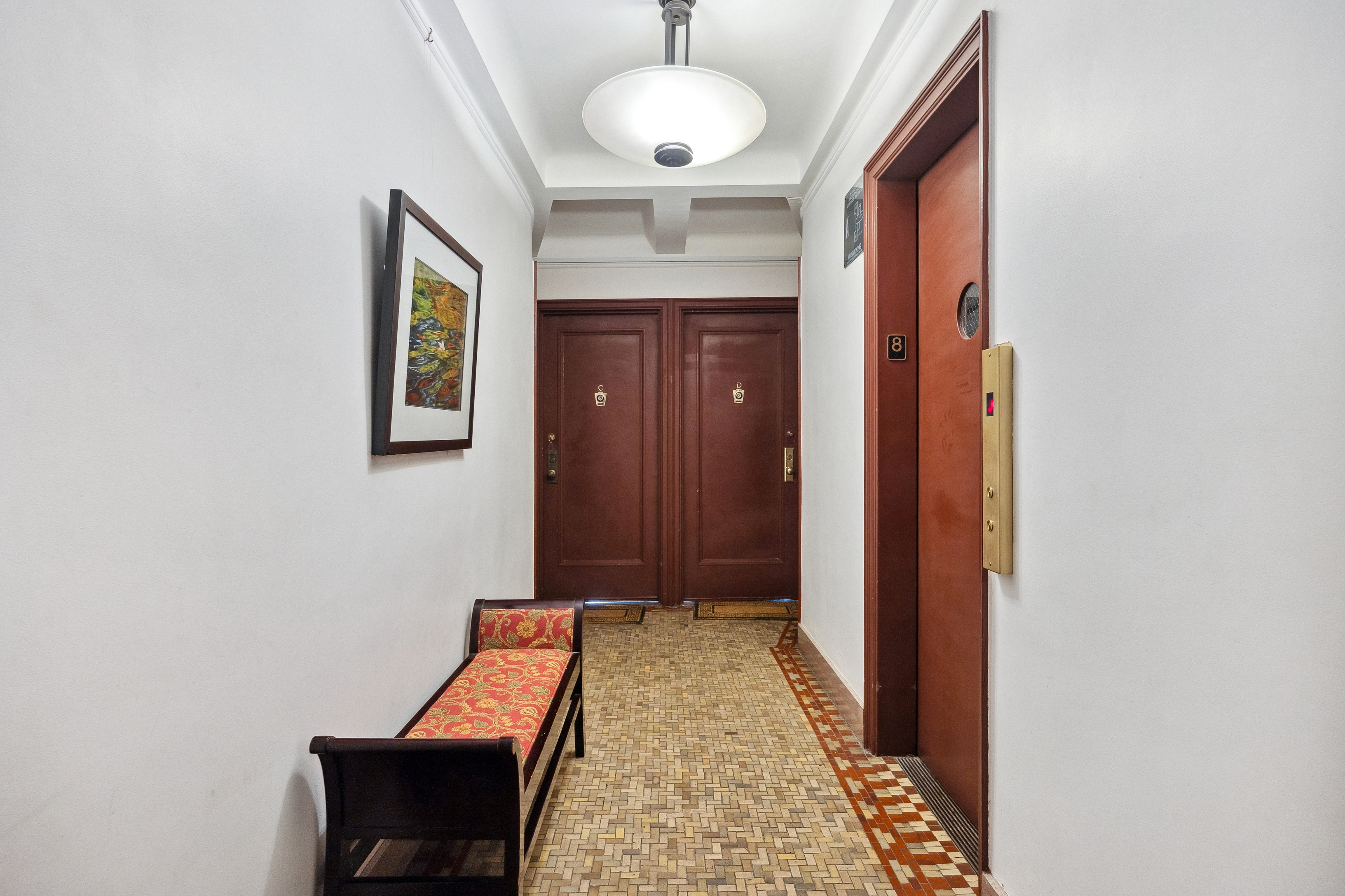 40 West 77th Street, Unit 8C Manhattan, NY 10024 - Photo 16 of 21 a view of a hallway with wooden floor and a chandelier